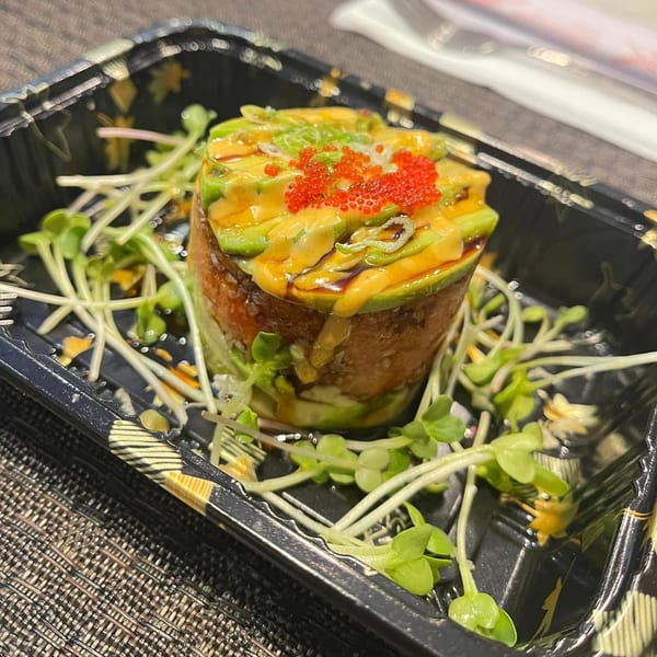 Ninja Japanese Restaurant's tuna tartare with avocado, spicy mayo, and tobiko, garnished with sprouts.